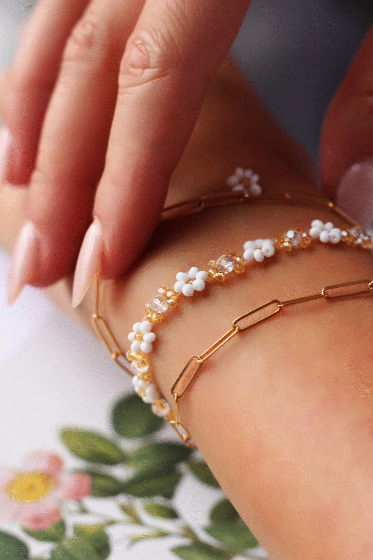 A close-up image showcasing the Seraphina handmade bracelet by RBK & Co., featuring iridescent lavender beads and white daisies. The photo highlights the bracelet’s soft glow and delicate craftsmanship, intended to evoke an ethereal, dreamy aesthetic for marketing and product presentation.